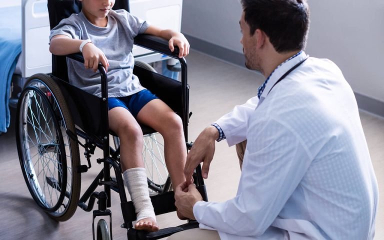 male-doctor-interacting-with-child-patient-in-ward-2021-08-28-17-19-07-utc.jpg